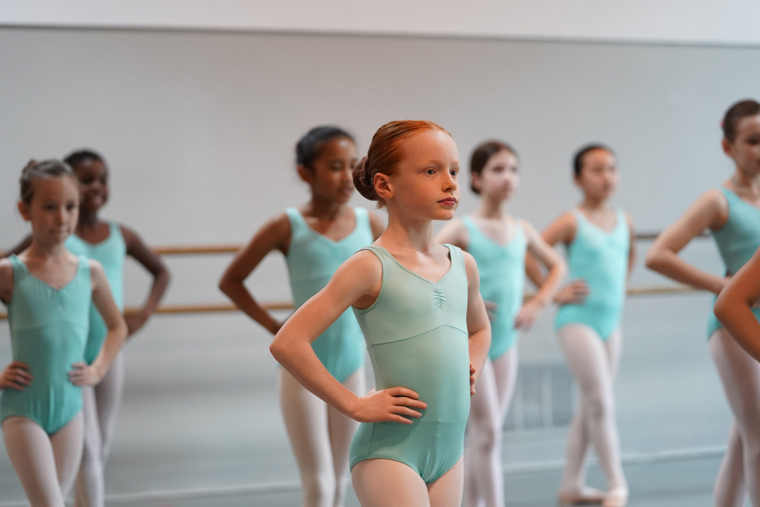 Youth class with students in teal leotards.