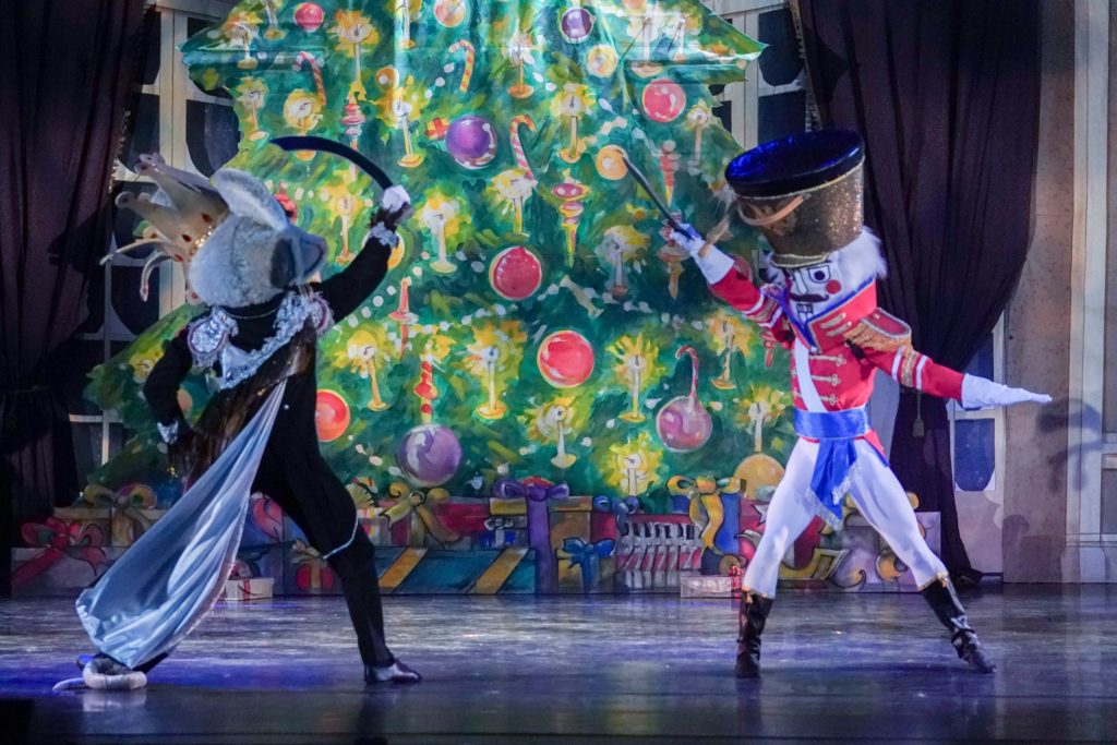 A scene from The Nutcracker with a toy solider and Mouse King.